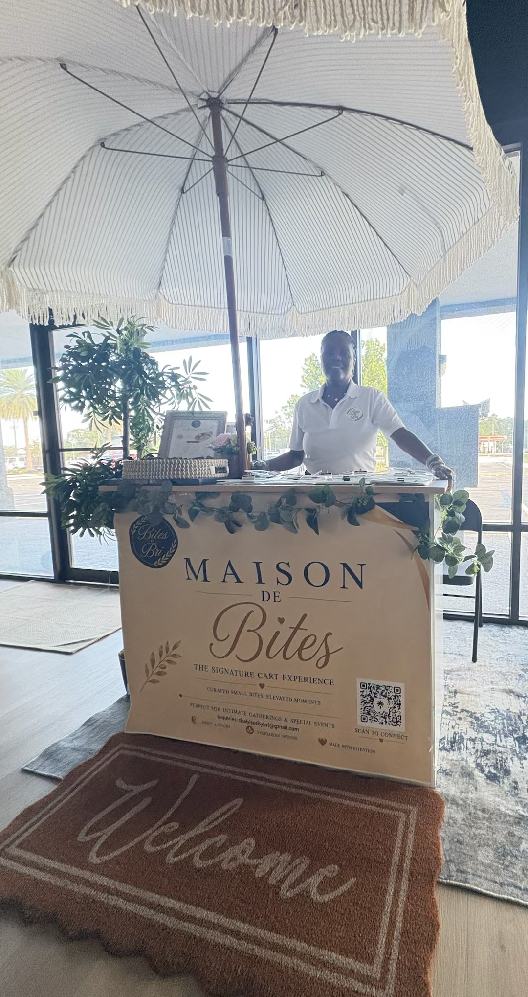 Bri welcoming guests at the Maison de Bites cart